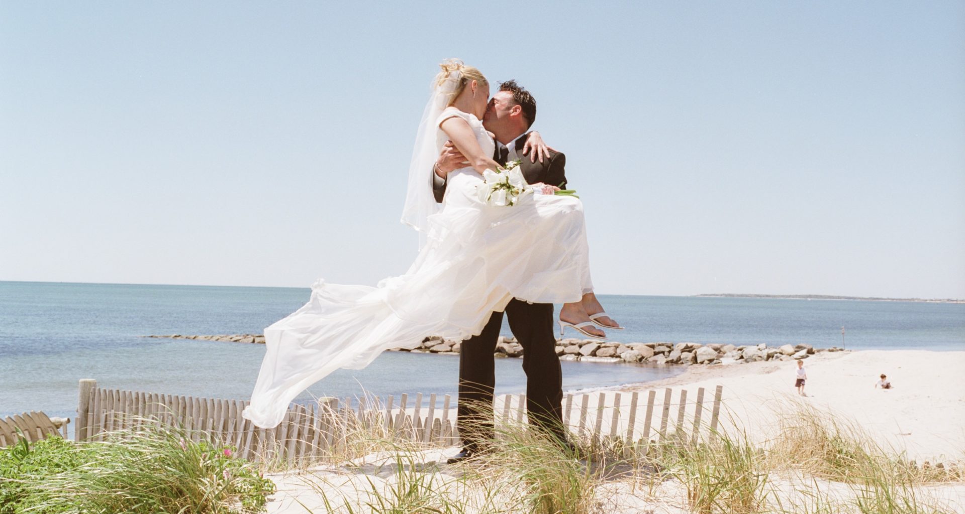 Summer newlyweds on Cape Cod beach