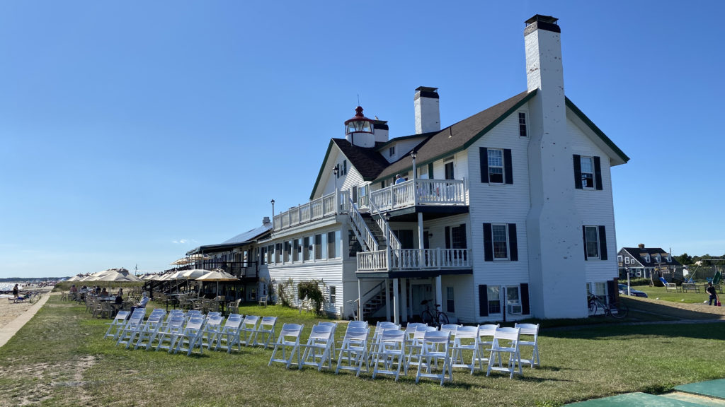 chairs set up for event with inn behind