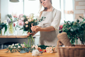 A Cape Cod wedding florist working on an arrangement. 