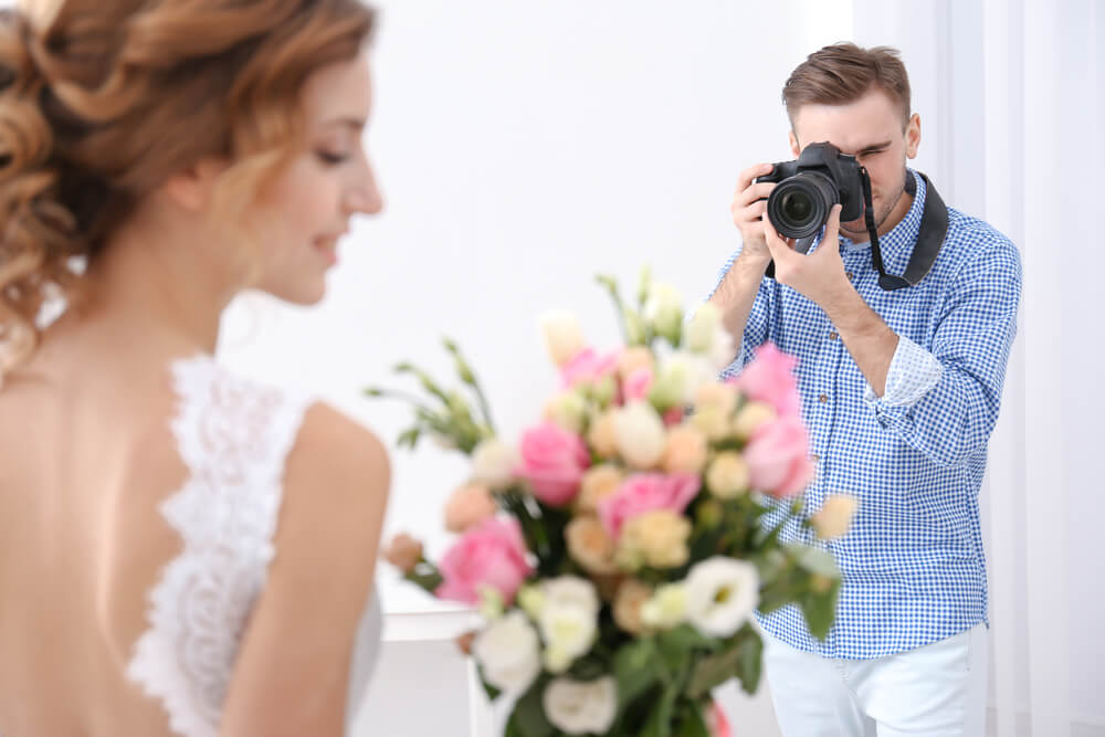 A Cape Cod wedding photographer taking photos of a bride.